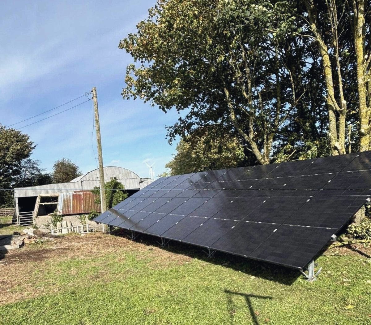 The ground-mounted array from the side, standing on its galvanised legs in the grass