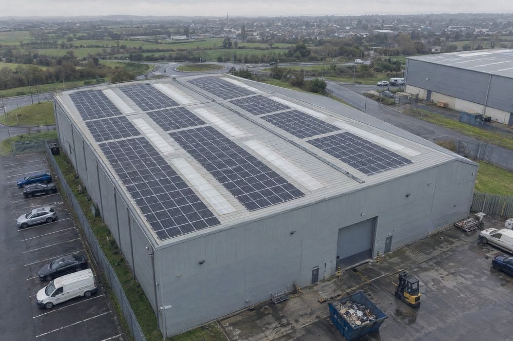 A business park warehouse roof covered in solar panels